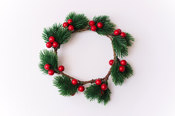 Fototapeta na wymiar Christmas wreath with red berries on a white background.