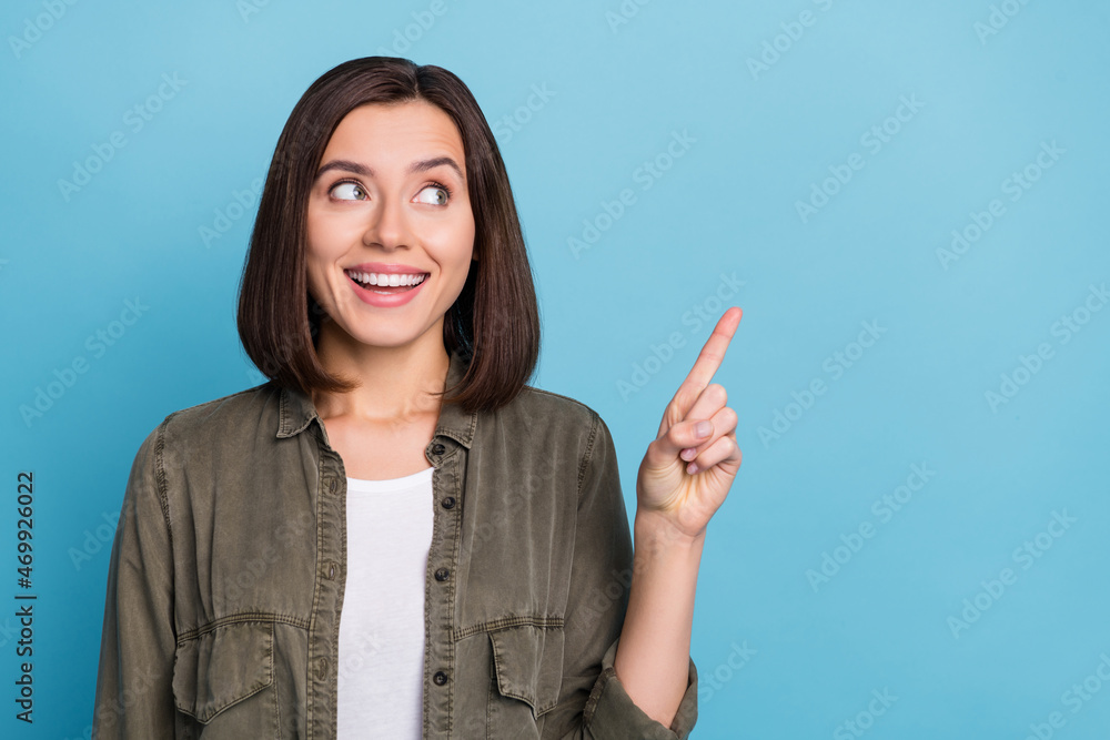 Sticker Photo of amazed promoter lady point hand empty space demonstrate adverts wear khaki outfit isolated over blue color background