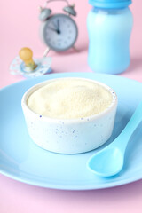 Concept of baby food with рowdered milk on pink background