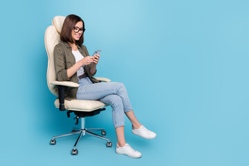Fototapeta na wymiar Full body photo of worker lady smm sit chair use app modern device texting social media post isolated over blue color background