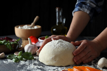 Concept of cooking pizza on dark textured table