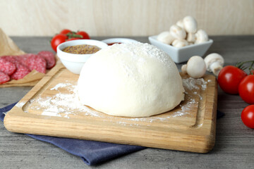 Concept of cooking pizza on gray wooden table