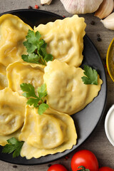 Delicious food concept with ravioli on textured background