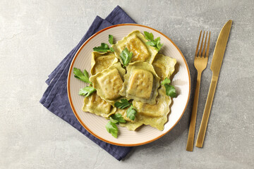 Delicious food concept with ravioli on gray background