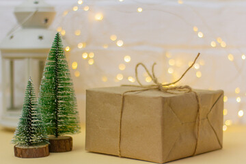 Craft paper gift boxes and small Christmas trees, copy space. Christmas concept.