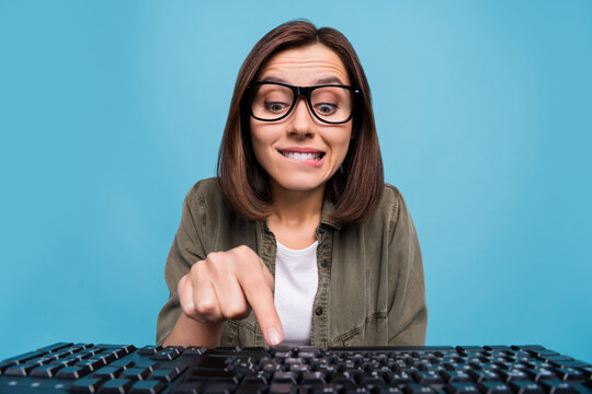 Photo of interested computer nerd lady try press button keyboard search web site camera isolated over blue color background