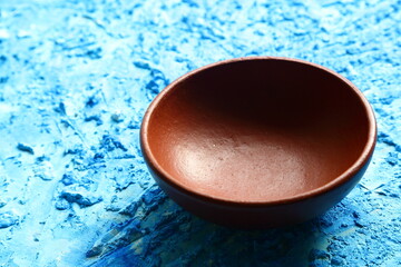 Earthenware  cooking bowl, on a rustic background.