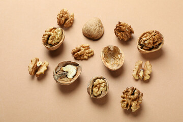 Flat lay composition with walnuts on brown background