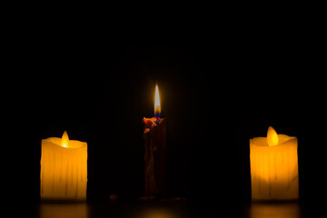 Christmas advent candle light in dark background well used for memorial day religious ritual, spiritual 
  zen meditation, peaceful mind and soul or funeral worship ceremony