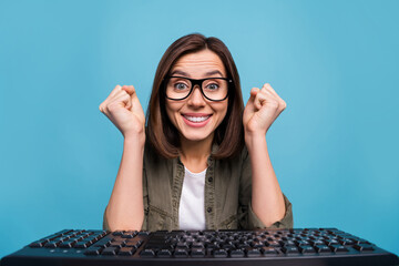 Photo of excited manager lady look web camera raise fists win lottery wear shirt isolated over blue...