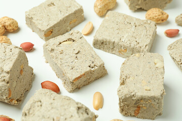 Halva with nuts on white background, close up