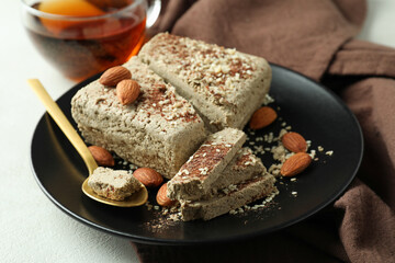 Concept of tasty food with halva on white textured background