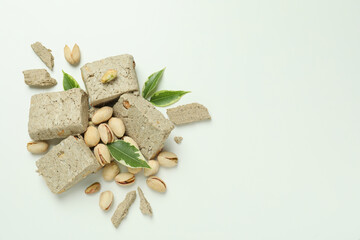 Halva with pistachio and leaves on white background