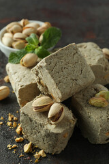 Concept of tasty food with halva on dark textured background