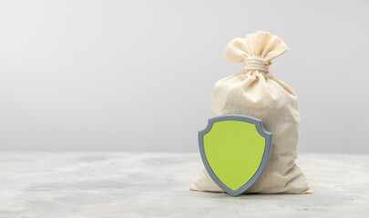 Money bag and with a shield. Savings insurance concept. Template Copy space for text.