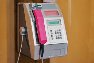 Public metal telephone box outdoor.