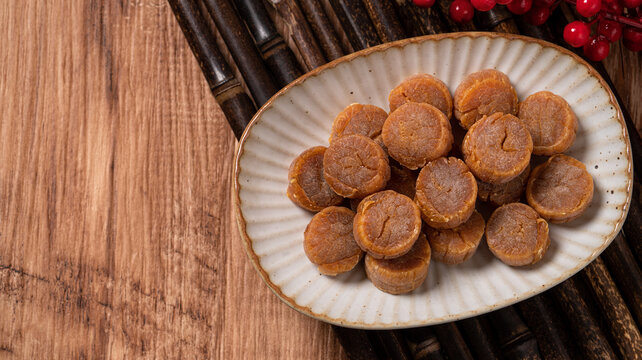 Dried scallop on wooden table.