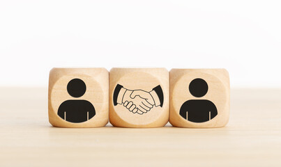 Agreement, partnership or deal concept. People and handshake Icons on wooden blocks. Copy space