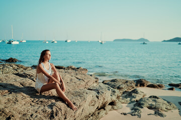 Outdoor portrait of young beautiful woman with long hair on the sea beach.