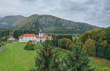 Sambata de Sus, Romania - 2021: Aerial view over Sambata de Sus orthodox Monastery. Religious landmarks in Romania at the bottom of Fagaras Mountains.