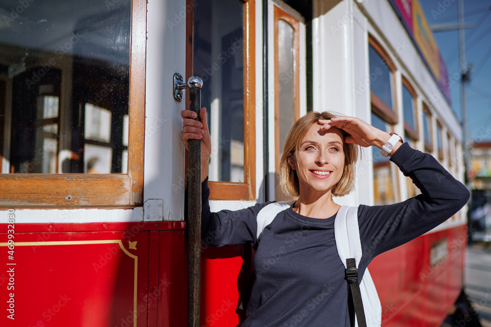 Wall mural Traveling by Portugal. Pretty  young woman riding on retro tram in Lisbon.