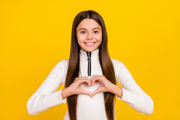 Photo of shiny charming student girl wear white zip shirt smiling showing hands arms heart isolated yellow color background