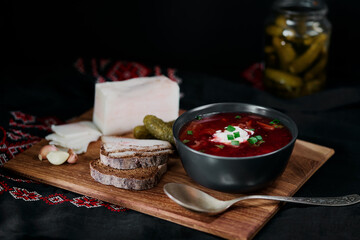 Fototapeta na wymiar Traditional ukrainian cuisine. Bowl with tasty red borscht soup.