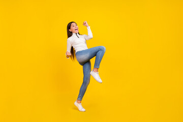Fototapeta na wymiar Full body photo of cool brunette small girl yell wear white pullover jeans shoes isolated on yellow color background