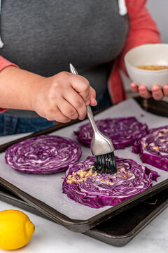 Woman making cabbage steaks 
