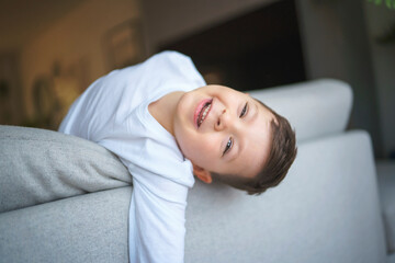 Little crazy boy on living room look like hyperactive