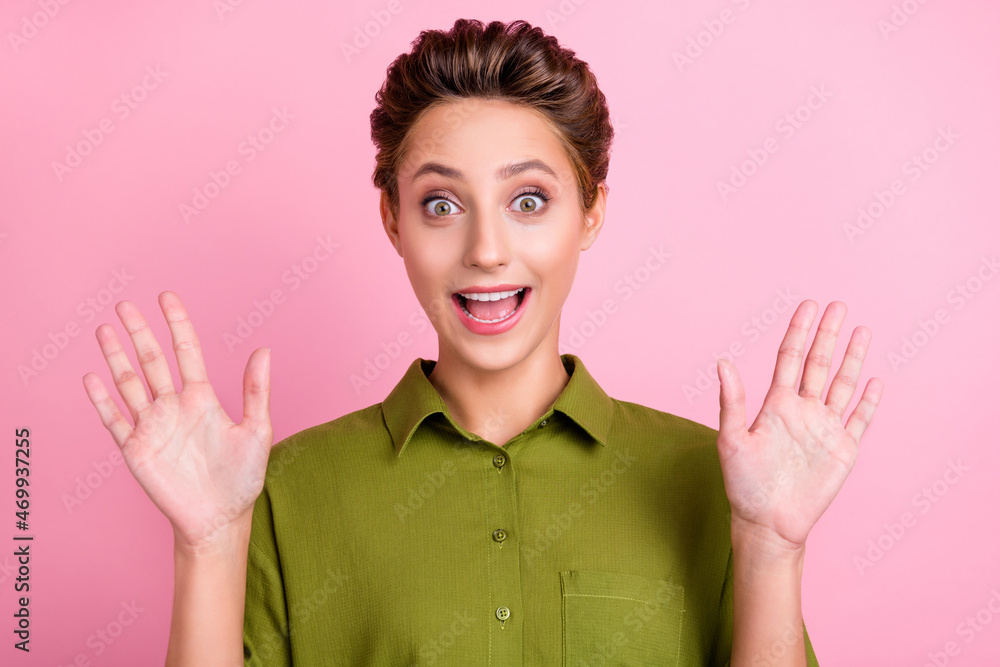 Poster Photo of excited cheerful lady raise hands open mouth wear green shirt isolated pink color background