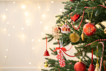 Christmas tree decorated with golden and red toys with bokeh background