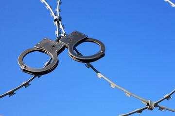 Old Handcuffs On Razor Wire