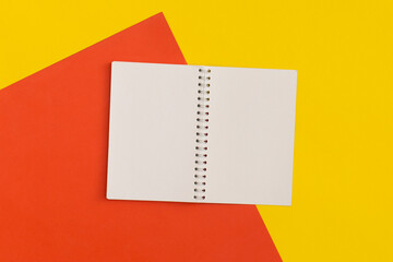 Notebook and pencil on color background. Top view. Flat lay. Back to school concept.