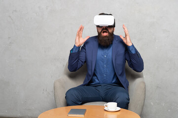 Shocked bearded man employee use immersive technology VR headset, virtual reality