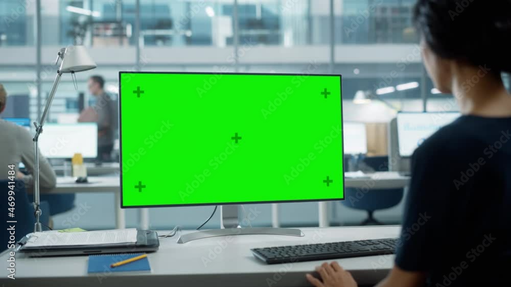 Poster Close Up Over the Shoulder Shot of a Businesswoman Working on Desktop Computer with Chroma Key Green Screen Mock Up Display. Digital Projects Manager Typing Data, Using Keyboard and Mouse.