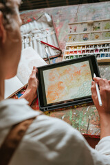 Close up of female artist or designer sketching on the digital tablet