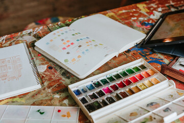 Close up of worktable with drawing and painting tools