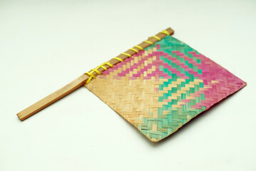 Traditional fan made of woven bamboo with a white background
