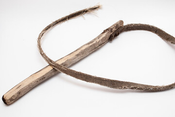 Old leather whip with wooden handle on white background