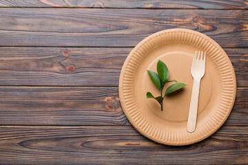 set of empty reusable disposable eco-friendly plates, cups, utensils on light white colored table background. top view. Biodegradable craft dishes. Recycling concept. Close-up