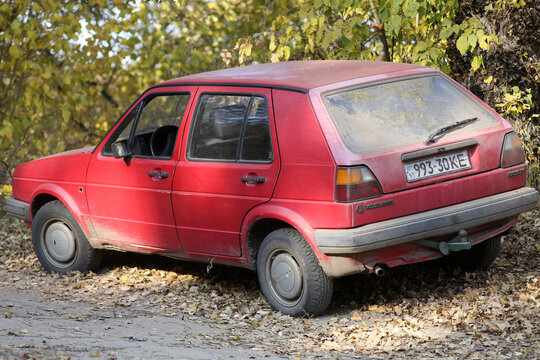 Popular old hatchback volkswagen golf mk2, red. Rear view. On forest road.
