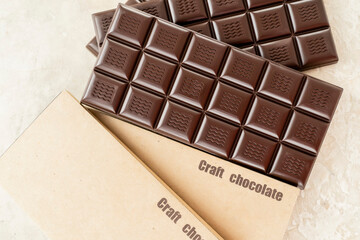 Handmade chocolate bar copy space. Black bitter craft chocolate on white background. Healthy food concept, delicious chocolate sweets, diet, sugar