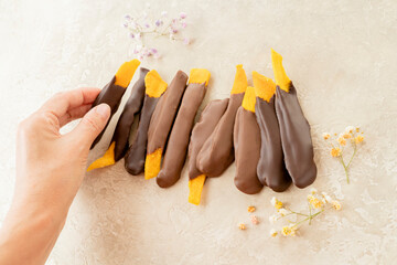Dried mango pieces in chocolate. Mango dried fruit sticks are doused with milk chocolate on a white...