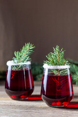 Cranberry red drink decorated with fir tree branches berry and sugar. Christmas hot mulled wine