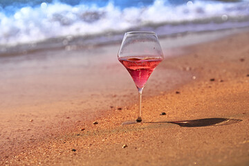 Wine glass with a cocktail by the sea.