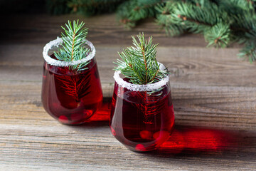 Cranberry red drink decorated with fir tree branches berry and sugar. Christmas hot mulled wine