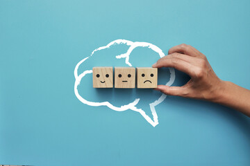 The silhouette of the brain and a variety of emotions in it. The symbol of the choice of sadness