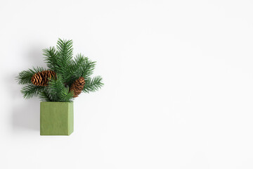 Christmas minimum composition. Christmas decor, fir tree branches, pine cone in gift box on white...