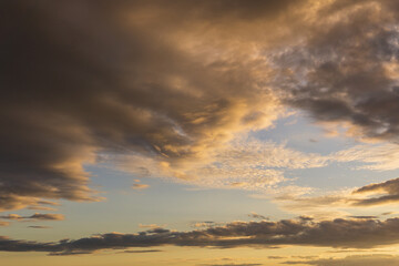 Obraz na płótnie Canvas bright golden color sunset clouds on beautiful sky